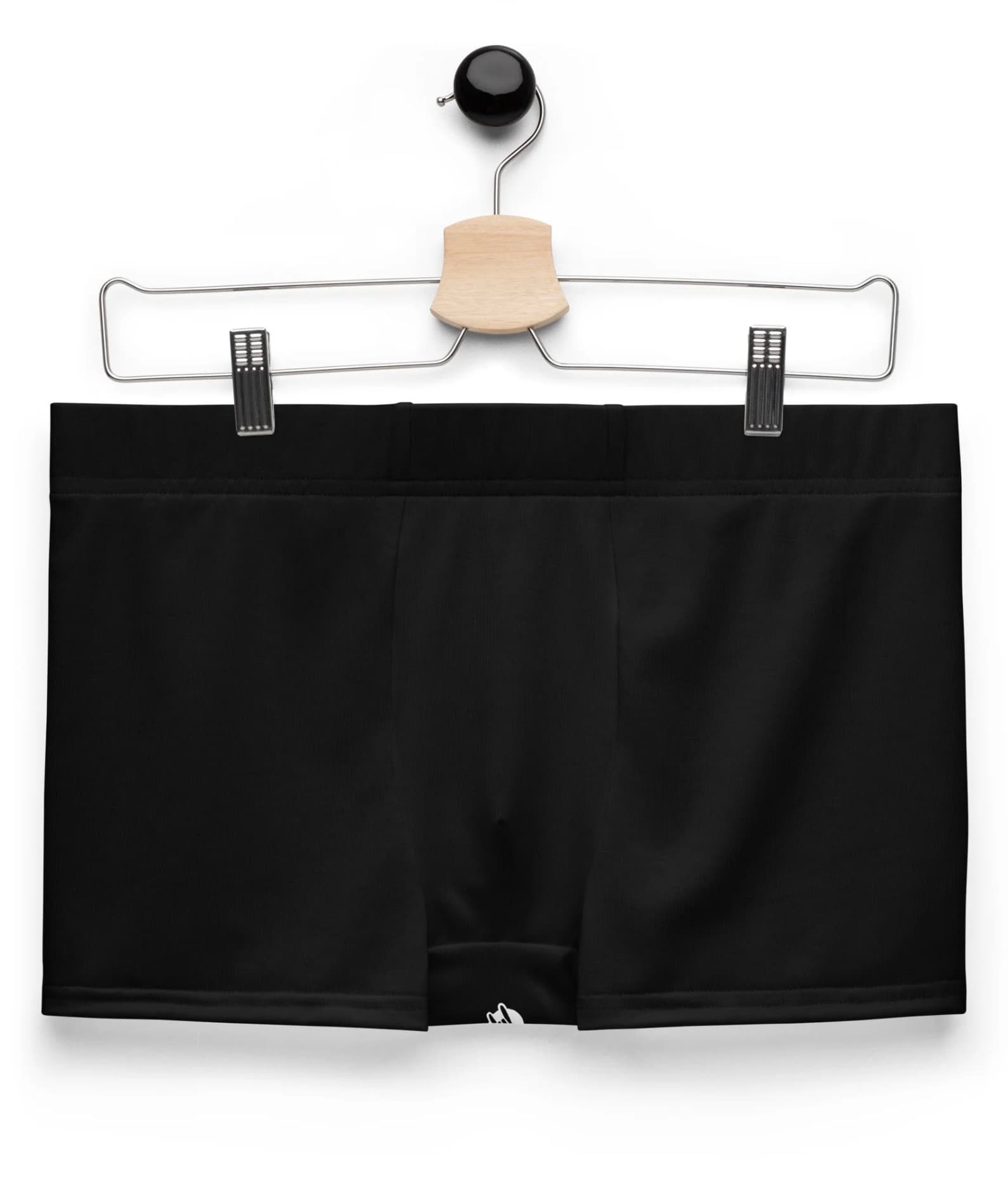 The black Classic Garment Bottoms on a wooden hanger.
