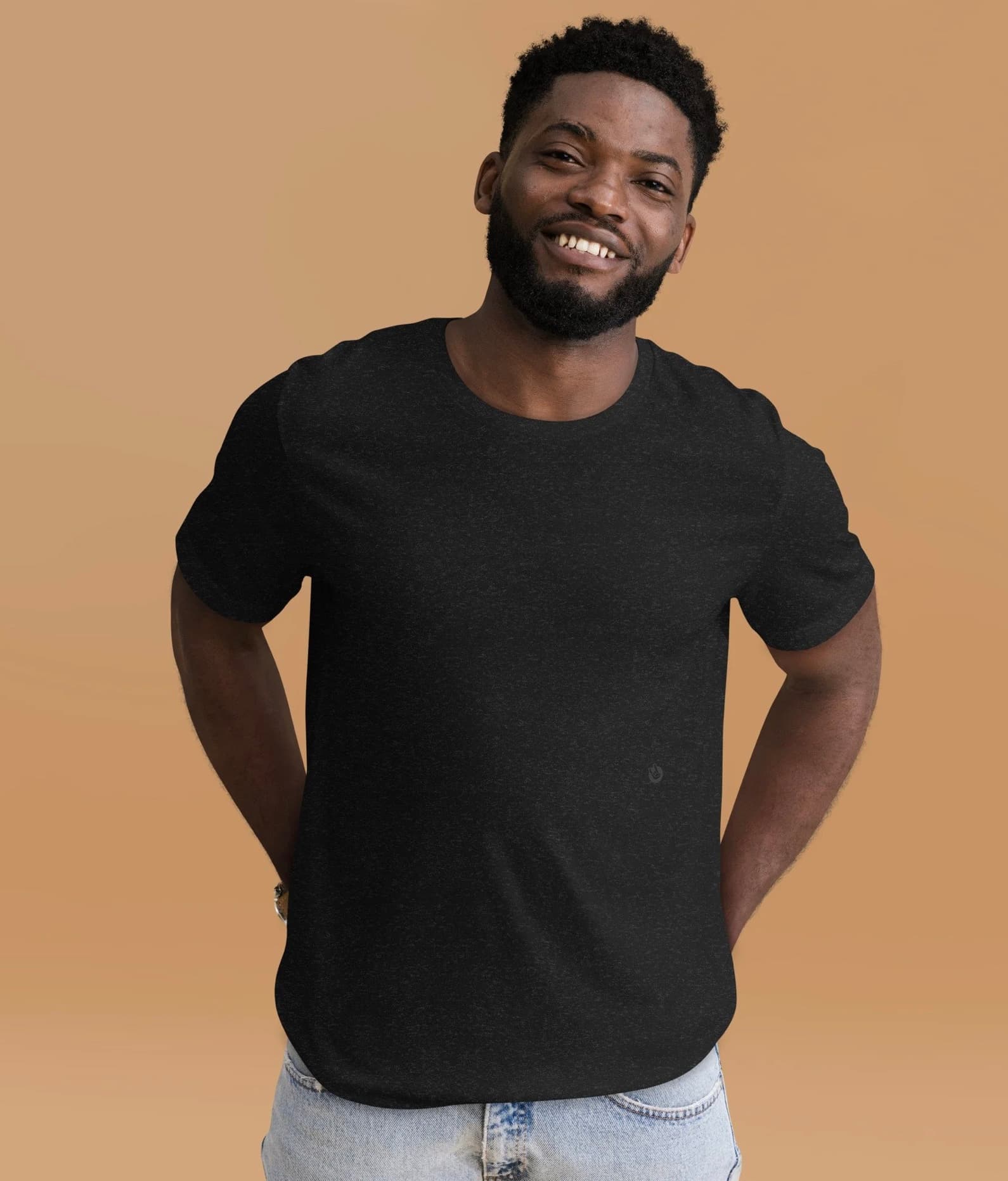 A smiling man wearing the black heather Classic Garment Top.